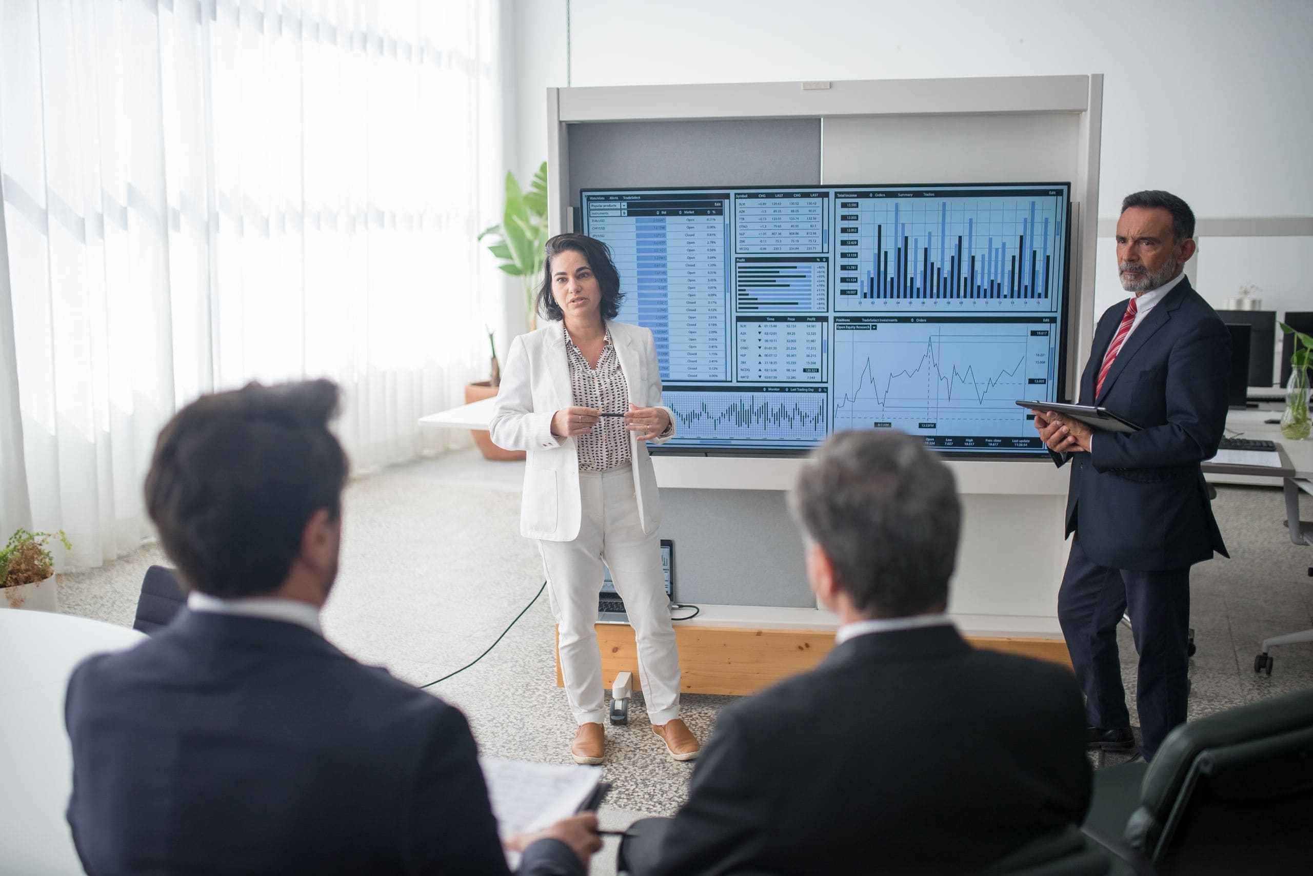 Advisors and clients reviewing a portfolio plan together at a boardroom table